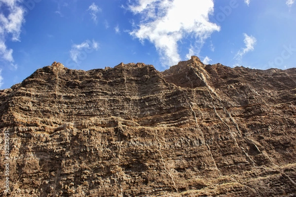 Fototapeta Cliff of colored rocks. Los Gigantes rocks - a close-up view from below.