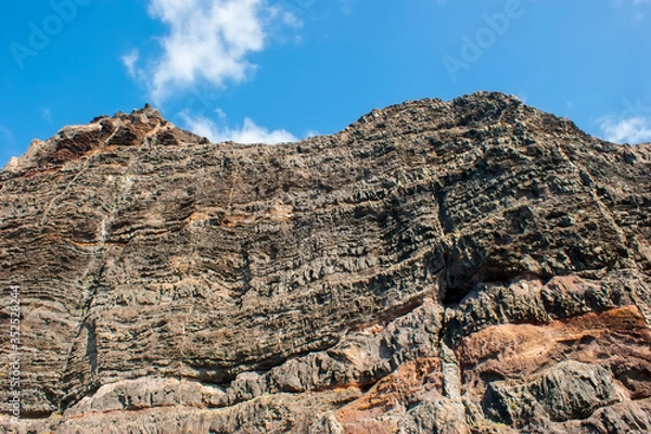 Fototapeta Cliff of colored rocks. Los Gigantes rocks - a close-up view from below.