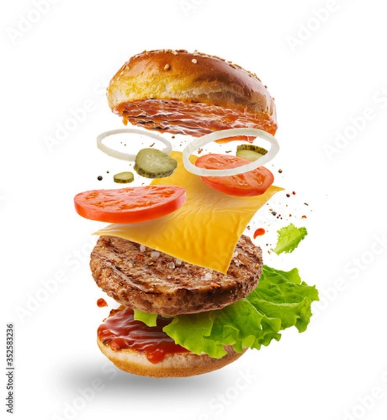 Obraz Burger z latającymi elementami. Pyszny burger z latającymi składnikami na białym tle. Latające plastry burgera.