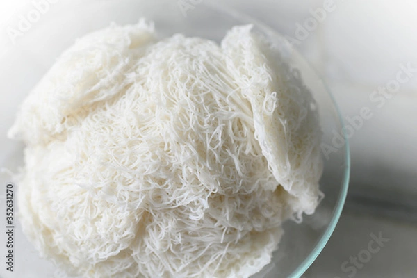 Obraz Idiyappam or string hoppers is a popular traditional breakfast cuisine of Kerala, South India. Rice flour pressed into white noodle form and then steamed.