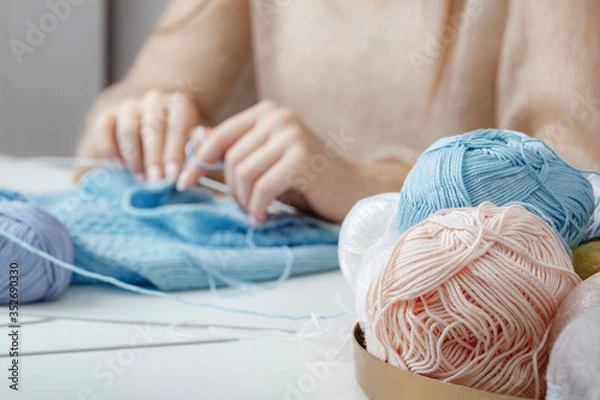 Fototapeta balls for knitting on the background of hands