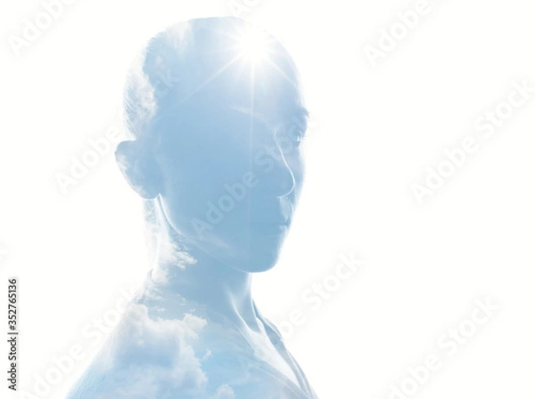Fototapeta  Mystical female person silhouette in double exposure with sun and cloudy sky