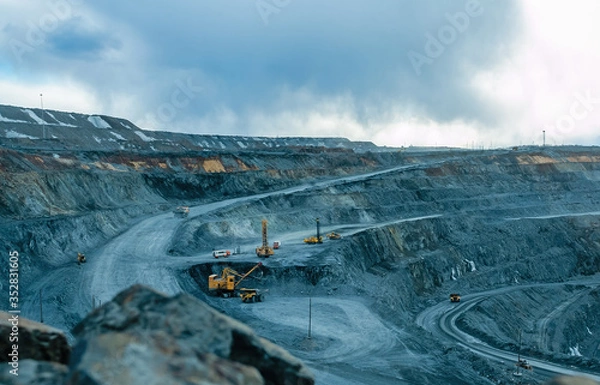 Fototapeta Work of trucks and the excavator in an open pit