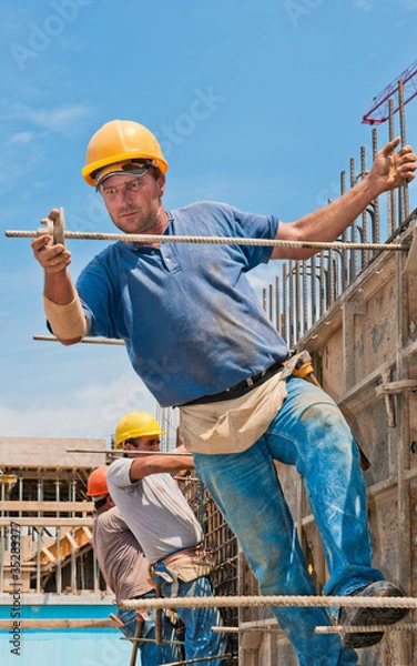 Obraz Construction workers installing formwork frames