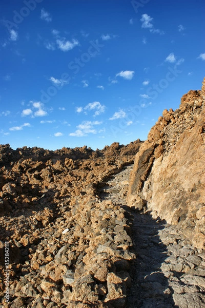 Fototapeta The way to the top of the Teide volcano. Stone path in the mountains to the top.