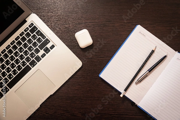 Obraz Notebook, pen, pencil and notebook on the table. Remote work.
