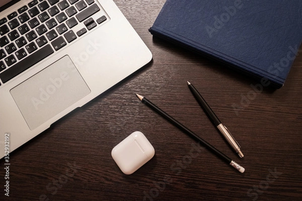 Obraz Notebook, pen, pencil and notebook on the table. Remote work.