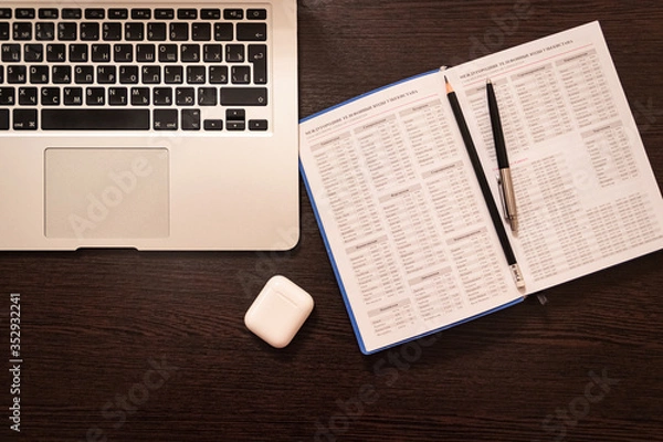 Obraz Notebook, pen, pencil and notebook on the table. Remote work.