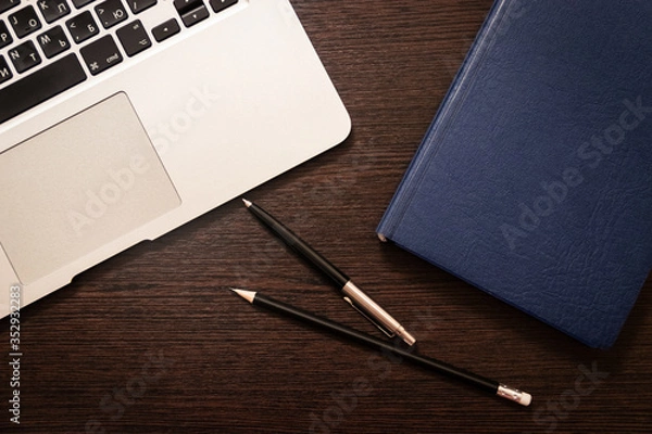 Obraz Notebook, pen, pencil and notebook on the table. Remote work.