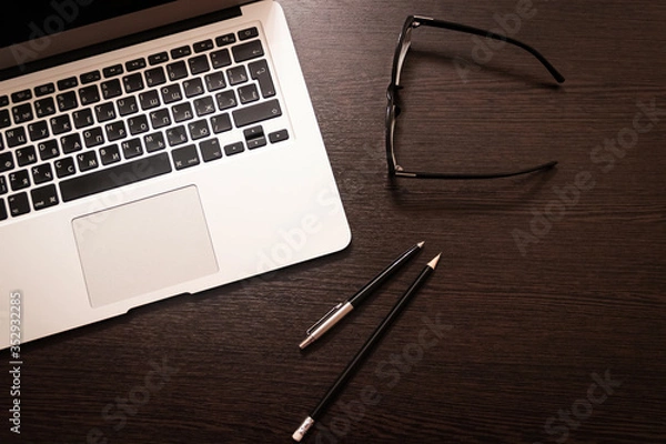 Obraz Notebook, pen, pencil and notebook on the table. Remote work.