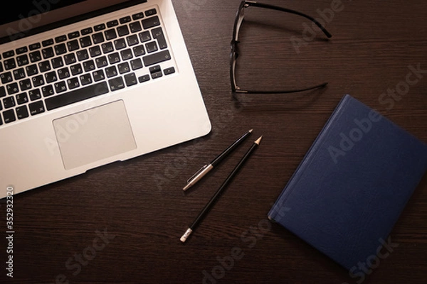 Obraz Notebook, pen, pencil and notebook on the table. Remote work.
