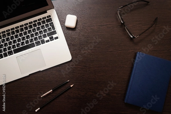 Obraz Notebook, pen, pencil and notebook on the table. Remote work.