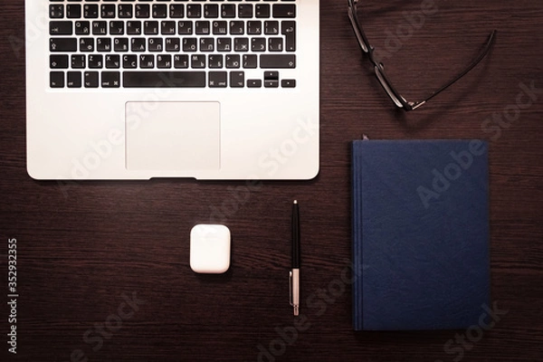 Obraz Notebook, pen, pencil and notebook on the table. Remote work.