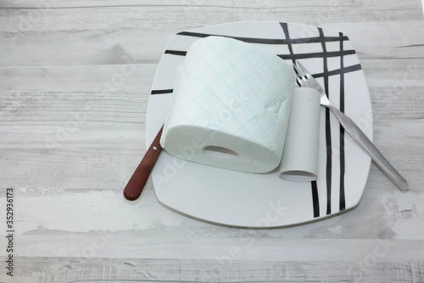 Fototapeta Plate with roll of toilet paper