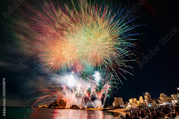 Fototapeta Blanes, Catalonia, Spain-July 2018: 48th International Firework Competition of the Costa Brava. The internationally recognized fireworks competition “El Focs de Blanes” takes place every July.