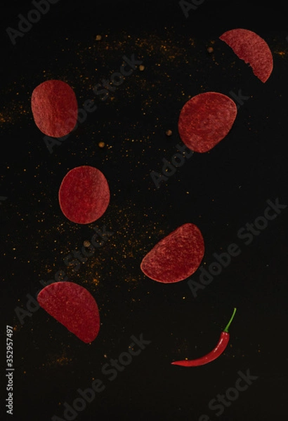 Obraz red chips that fly on a black background