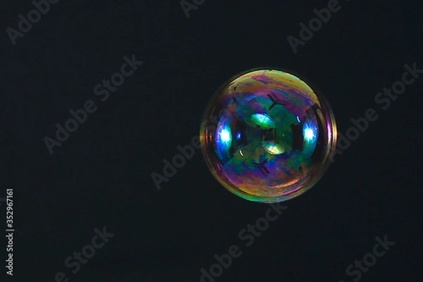 Fototapeta Beautiful rainbow soap bubble on a black background
