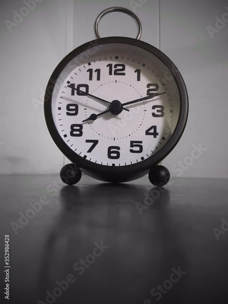 Obraz A waker clock on the table in black and white view