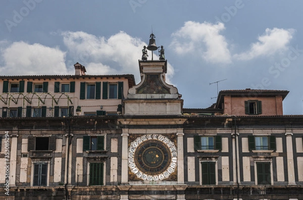 Obraz Old astronomical clock on the facade of the building. Brescia, Italy. Soft focus, blurry background.