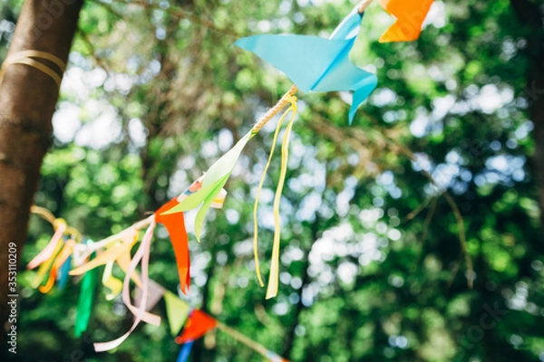 Fototapeta color party birthday flags in green forest