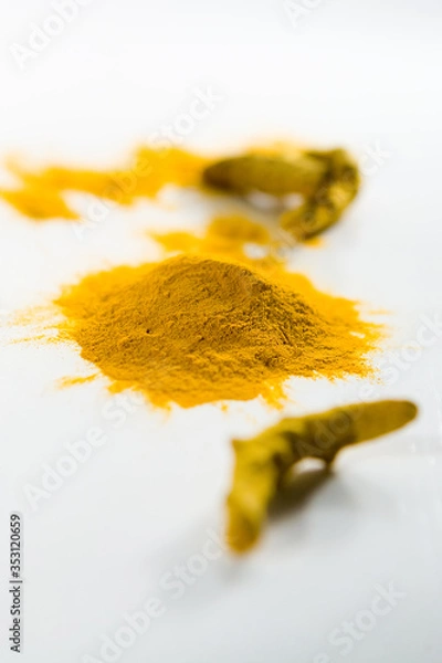 Fototapeta Heap of the colorful turmeric on the white table