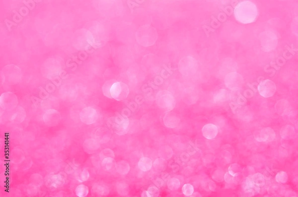 Fototapeta Pink defocused glitter background with copy space. Christmas background. Pink holiday glowing abstract background. Fuchsia blurred bokeh