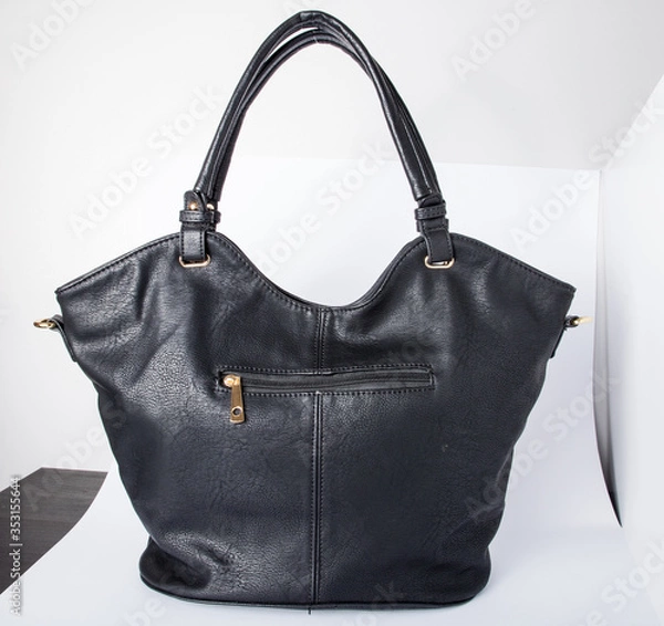 Obraz London, England, 20/02/2020 Black real authentic leather bag shot on a white background ready for photoshop composition for e commerce product photography by professional for editing