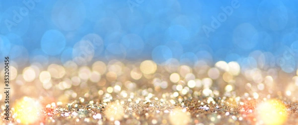 Fototapeta Christmas light background.  Holiday glowing backdrop. Defocused Background With Blinking Stars. Blurred Bokeh.
