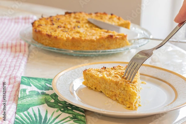 Obraz Homemade Roasted vegetable quiche pie with a wedge cut out. Delicious vegetarian food. freshly baked
Onions carrots squash courgettes KUGEL 
1 slice in a plat with a fork eating 