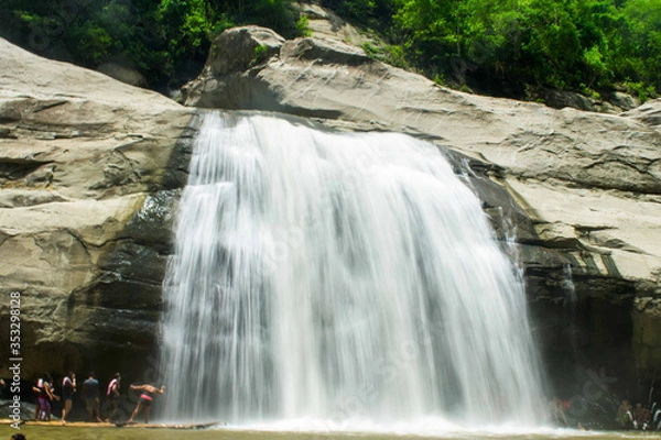 Obraz Tourist flock at the Tangadan falls in La Union Pangasinan Philippines. Big rock formations