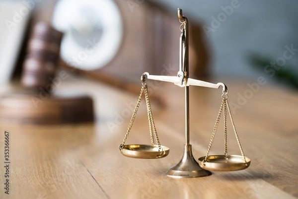 Fototapeta Law and Justice concept. Gavel of the judge, books, scales of justice. Gray stone background.