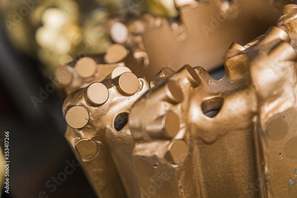 Obraz Macro shot of drill bits on shelving in stock. Oil drilling equipment for drilling rig operation on oil platform in oil and gas industry. Brand new PDC Polycrystalline Diamond Compact drilling bit