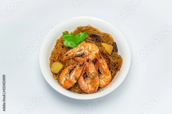Fototapeta Casseroled shrimps roasted with glass noodles or prawns with Vermicelli Noodles in white blow with chinese celary on the top view. Asian Food Thai fusion style. famous food in Thailand national dish.