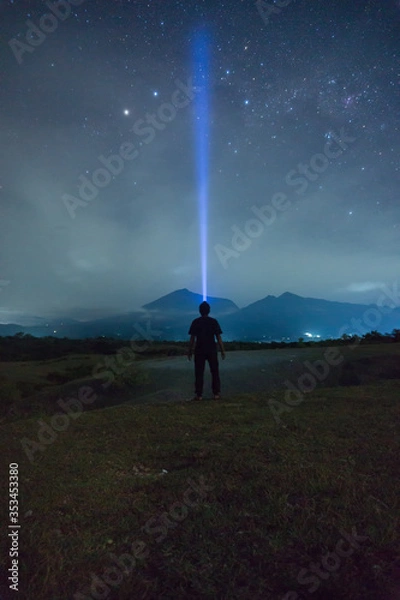 Obraz man in the night with mountain background