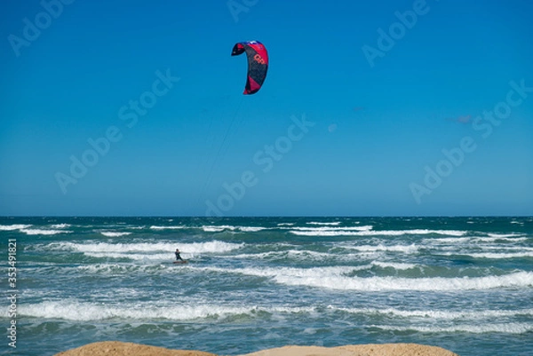 Obraz PALMA DE MALLORCA, SPAIN - MAY 11 2020 : Kite Surfer at the Playa de Palma  at  - Mallorca during Corona Lock down  on May 11, 2020 in Palma de Mallorca, .