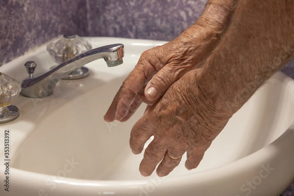 Fototapeta Bathroom sink two hands getting ready to wash
