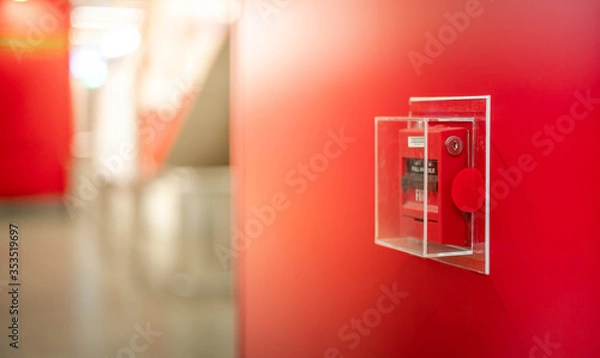 Fototapeta The red fire alarm switch on the red wall at the Bangkok subway.
