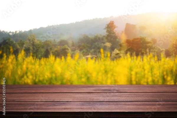 Fototapeta Empty wooden table space platform and blurred field or farm background for product display montage