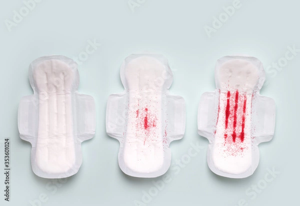 Obraz The menstrual cycle in women. Gaskets on a blue background