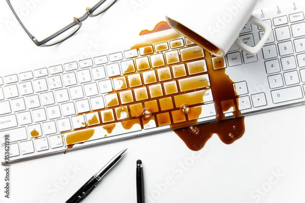 Fototapeta Cup of coffee spilled on office desk concept of careless clumsy or accident