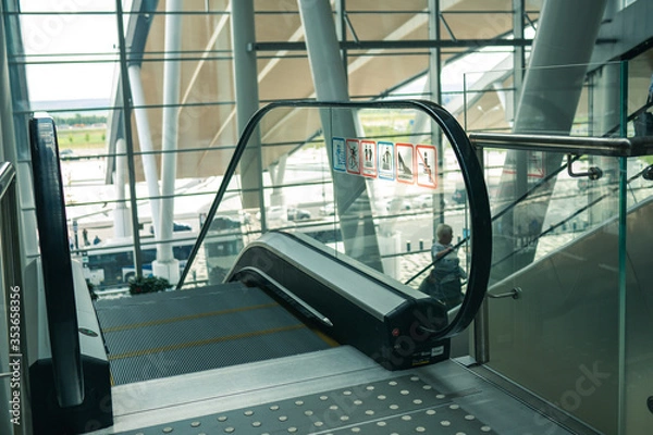 Fototapeta Clean escalator closeup at the airport. beautiful modern escalator top down view