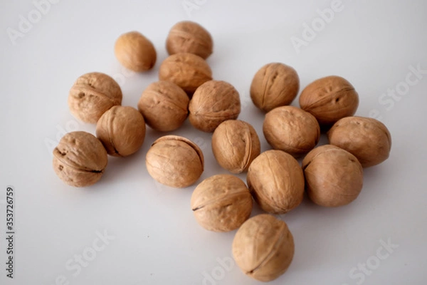 Obraz Walnuts spilled on a white table