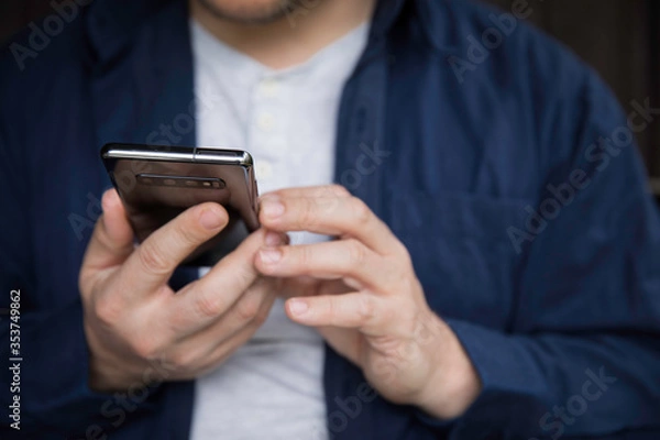 Obraz Man using smartphone, detail of hands.
