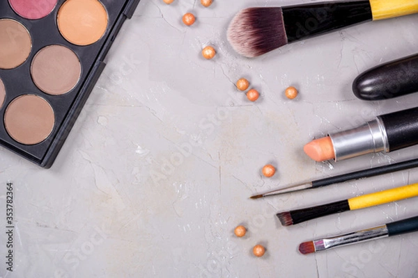 Fototapeta Unfolded open cosmetics on a gray background