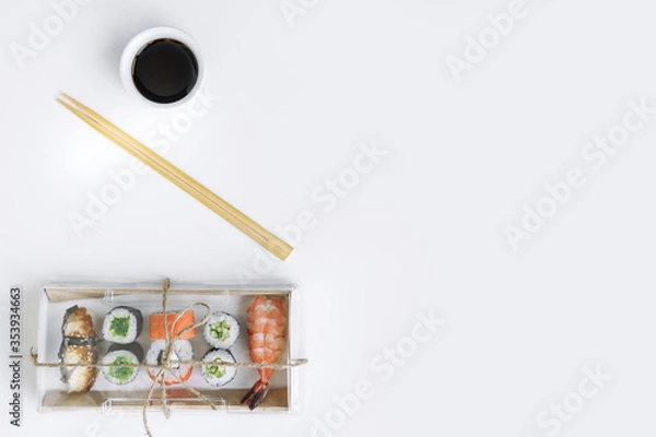 Fototapeta Sushi and rolls delivery service consept on white background (template, open space, top view).