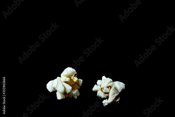 Fototapeta two popcorn on black background
