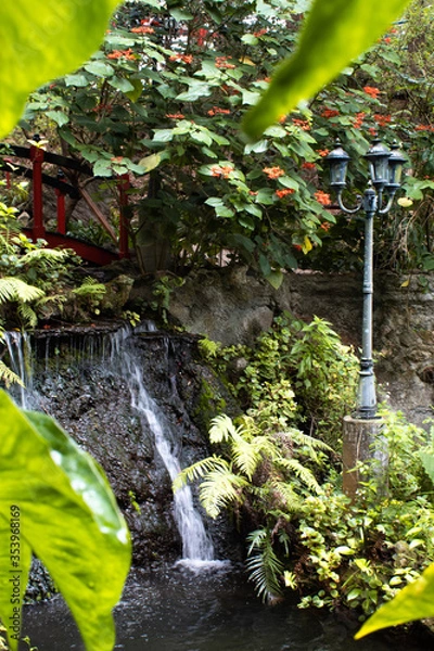 Fototapeta Waterfall, bridge, and street lamp.