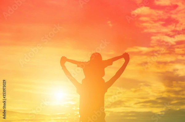 Fototapeta Mother encouraged her daughter out of the shadows at sunset.