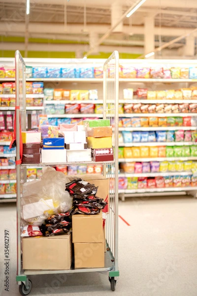 Fototapeta The goods of food and beverage at the supermarket shelf aisle prepare to shopper buy to hoarding for use in everyday in house.