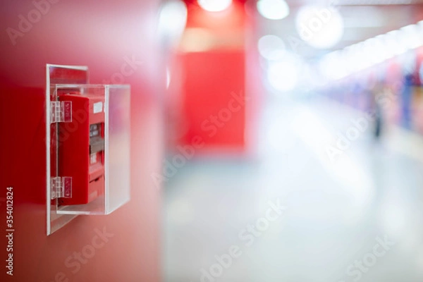 Fototapeta The red fire alarm switch on the red wall at the Bangkok subway.